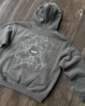 Gray hoodie with a white graphic design on a wooden floor